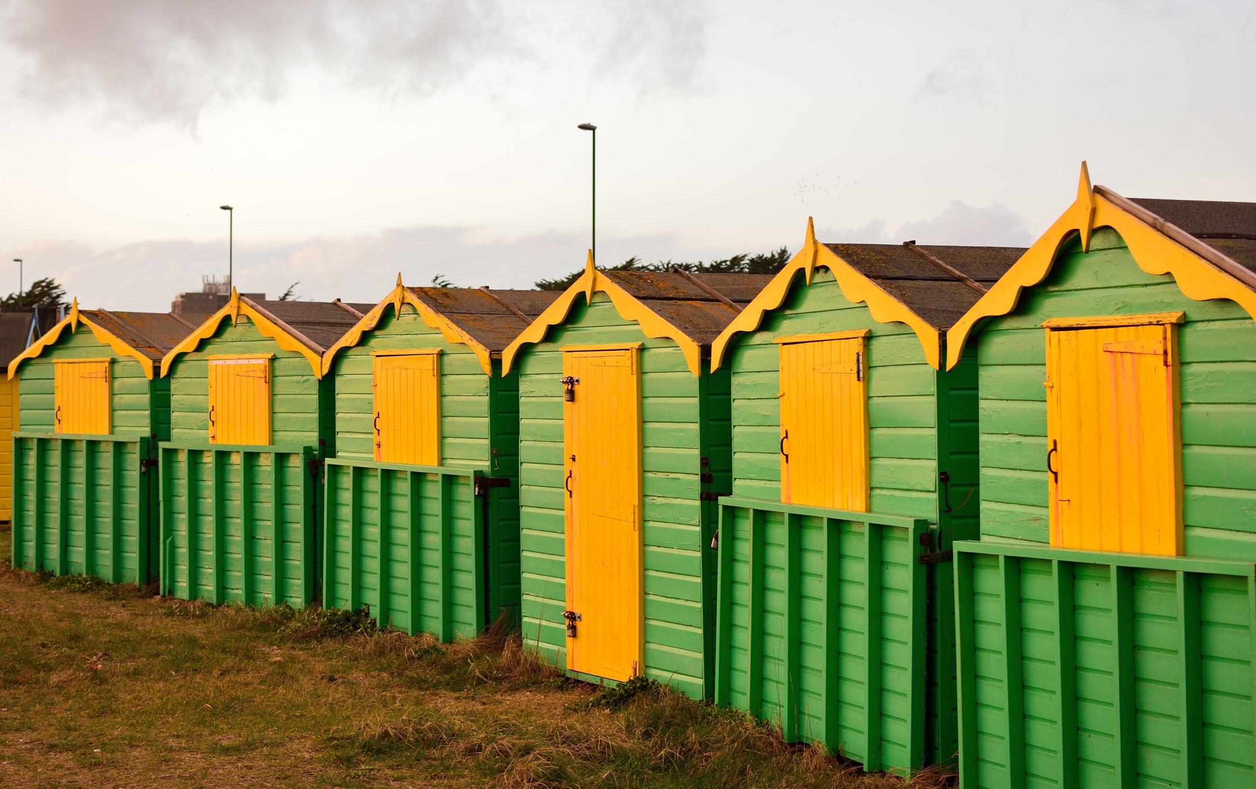 Small wooden green and yellow cottages in the rural area